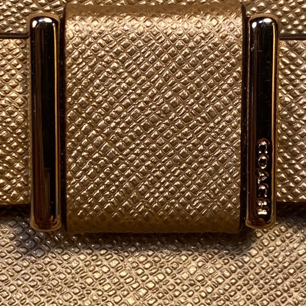 Coach gold metallic color cosmetic pouch w/elegant bow